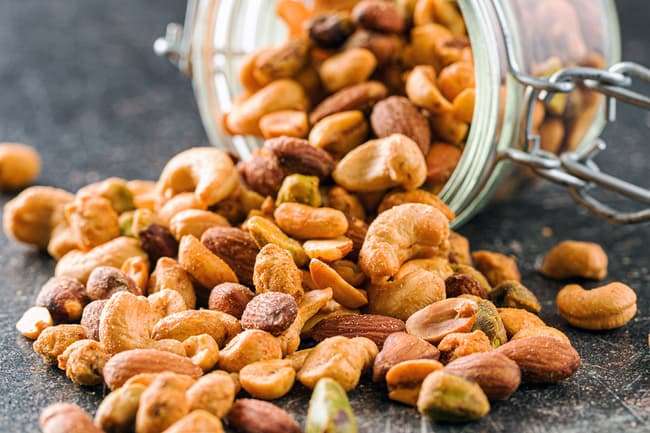 photo of mixed nuts spilling from jar