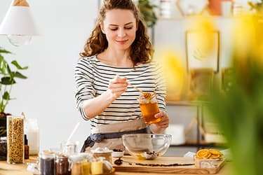 493ss_thinkstock_rf_smiling_woman_pouring_honey.jpg?resize=375px:250px&output-quality=50