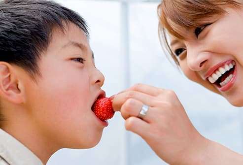 boy eating strawberry