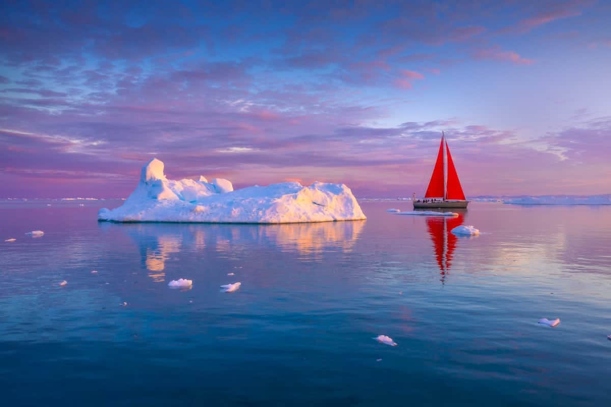 Beautiful Landscape With Iceberg on Water and a Red Boat